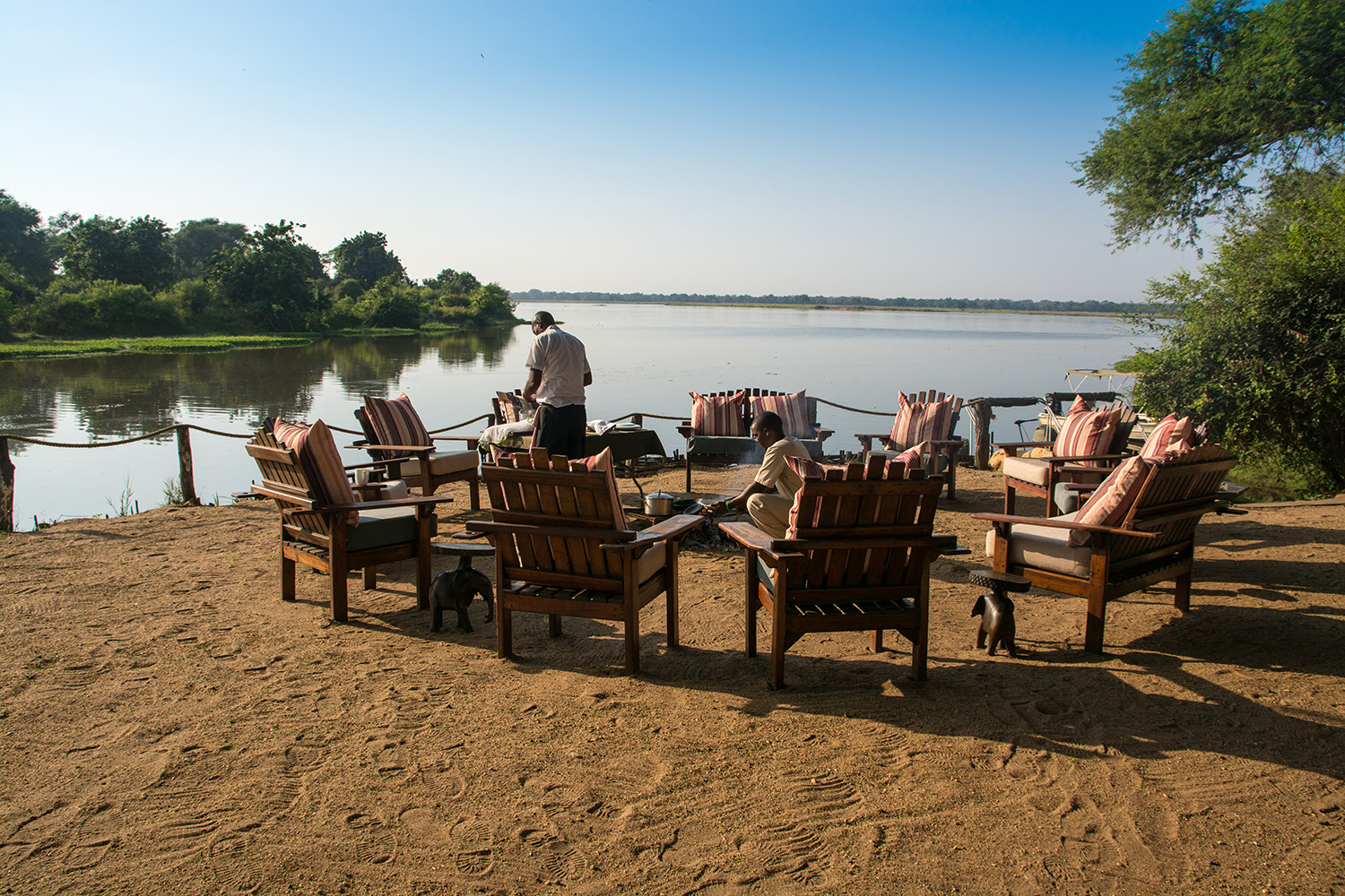 A fireplace being prepared for guests next to the river in Zambia