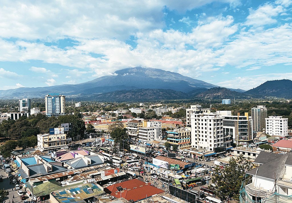 Arusha city, Tanzania, showcasing its vibrant urban landscape with a backdrop of beautiful mountains.