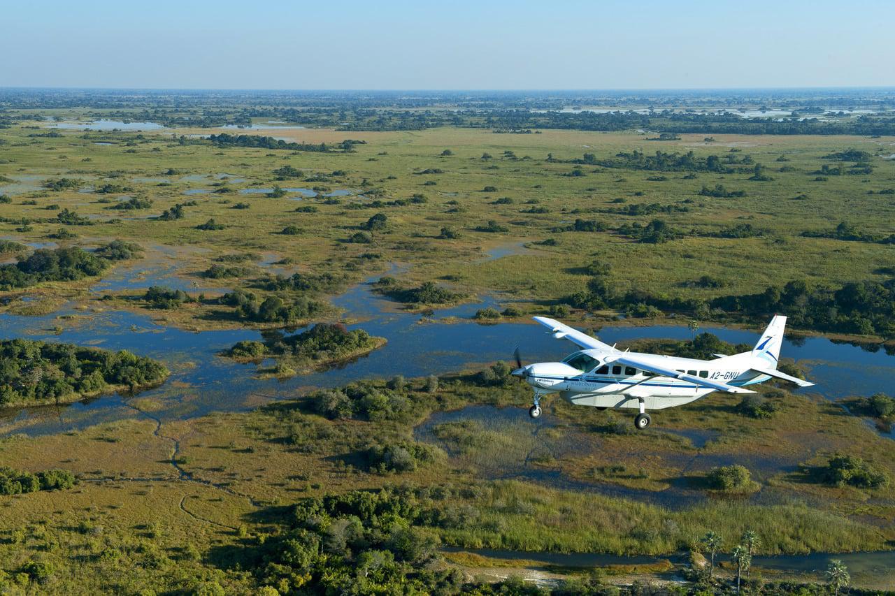 Maun: A breathtaking aerial view of the landscape with a light aircraft flying over the vast wilderness, showcasing the beauty and adventure of this gateway to the Okavango Delta.
