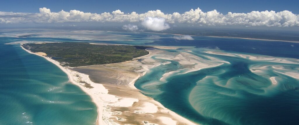 Mozambique: Aerial view of Benguerra Island, featuring the blue sea and lush landscape.