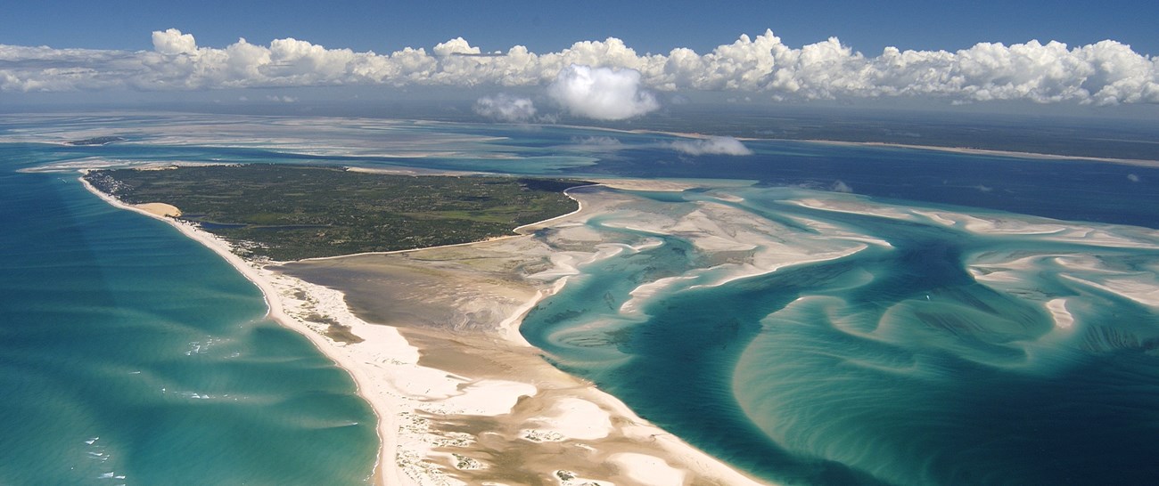 Mozambique: Aerial view of Benguerra Island, featuring the blue sea and lush landscape.