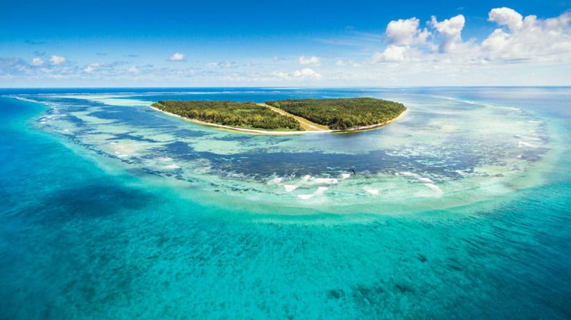 Seychelles Island, airview showcasing lush greenery, turquoise waters, and white sandy beaches as the main destination picture.