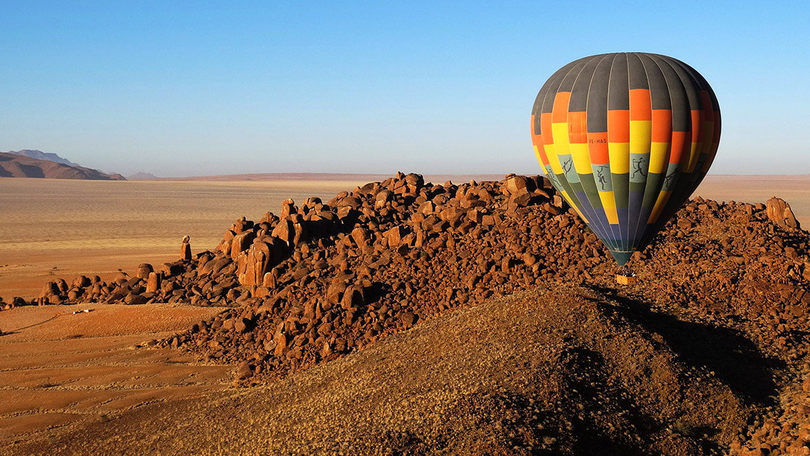 NamibRand Nature Reserve, Namibia - A breathtaking aerial view of the landscape with a hot air balloon, highlighting the beauty and tranquility of the reserve.