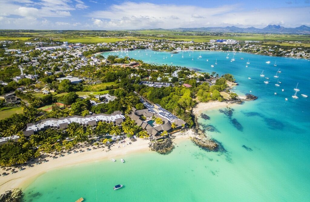 Mauritius East Coast - Belle Mare Beach, aerial view featuring the blue sea and picturesque coastline.