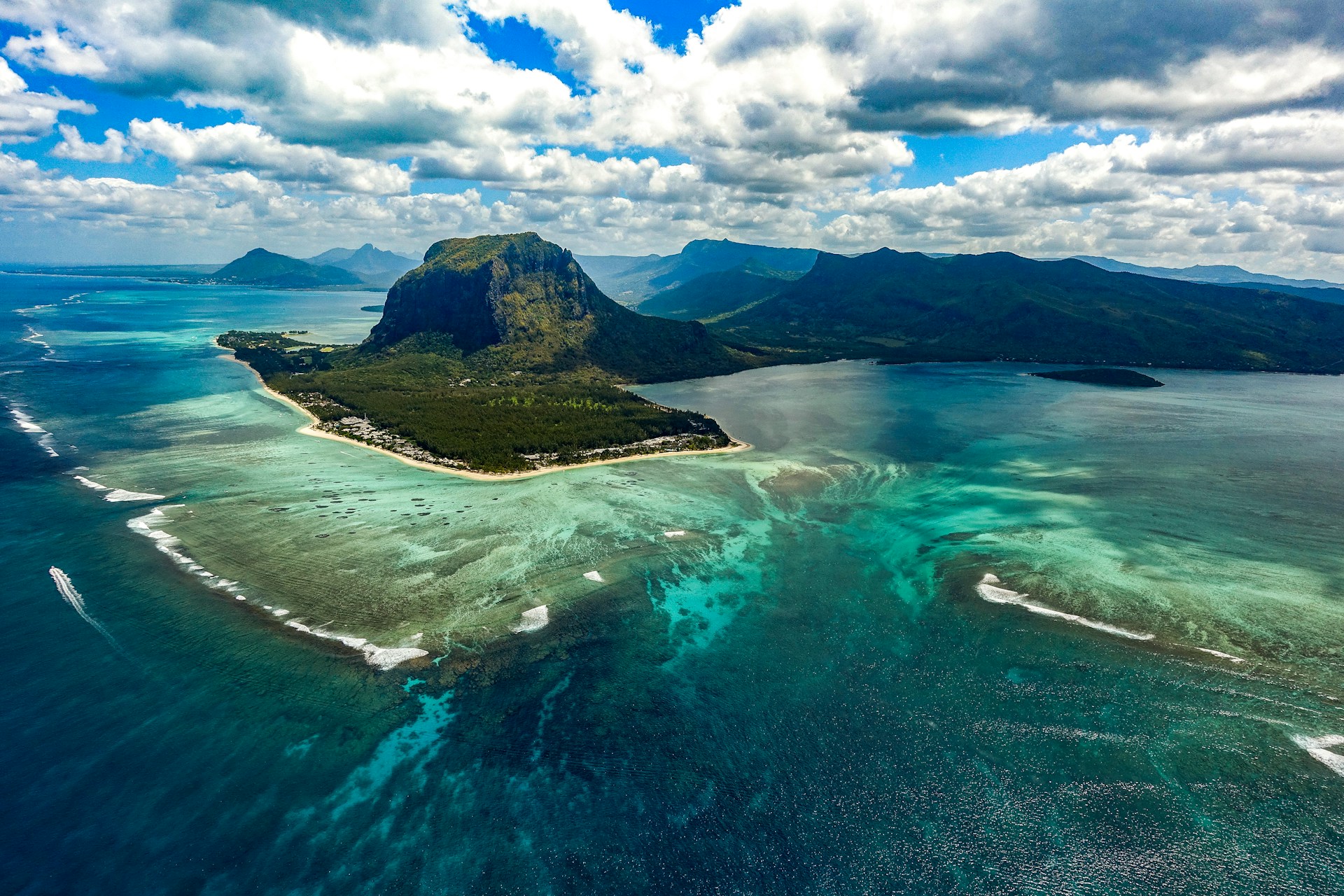 Mauritius : aerial view showcasing the stunning blue sea and majestic mountain on the east coast, highlighting the beautiful beach and scenic landscape. Flic en flac Beach