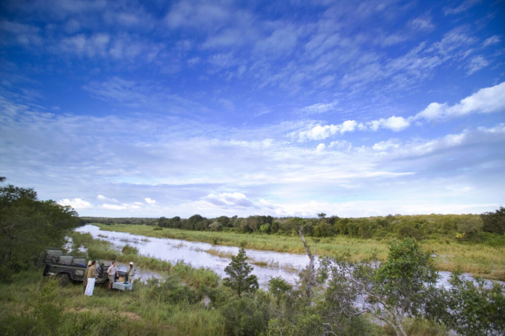 Guests having coffee at the river bank on Kirkman's Camp.