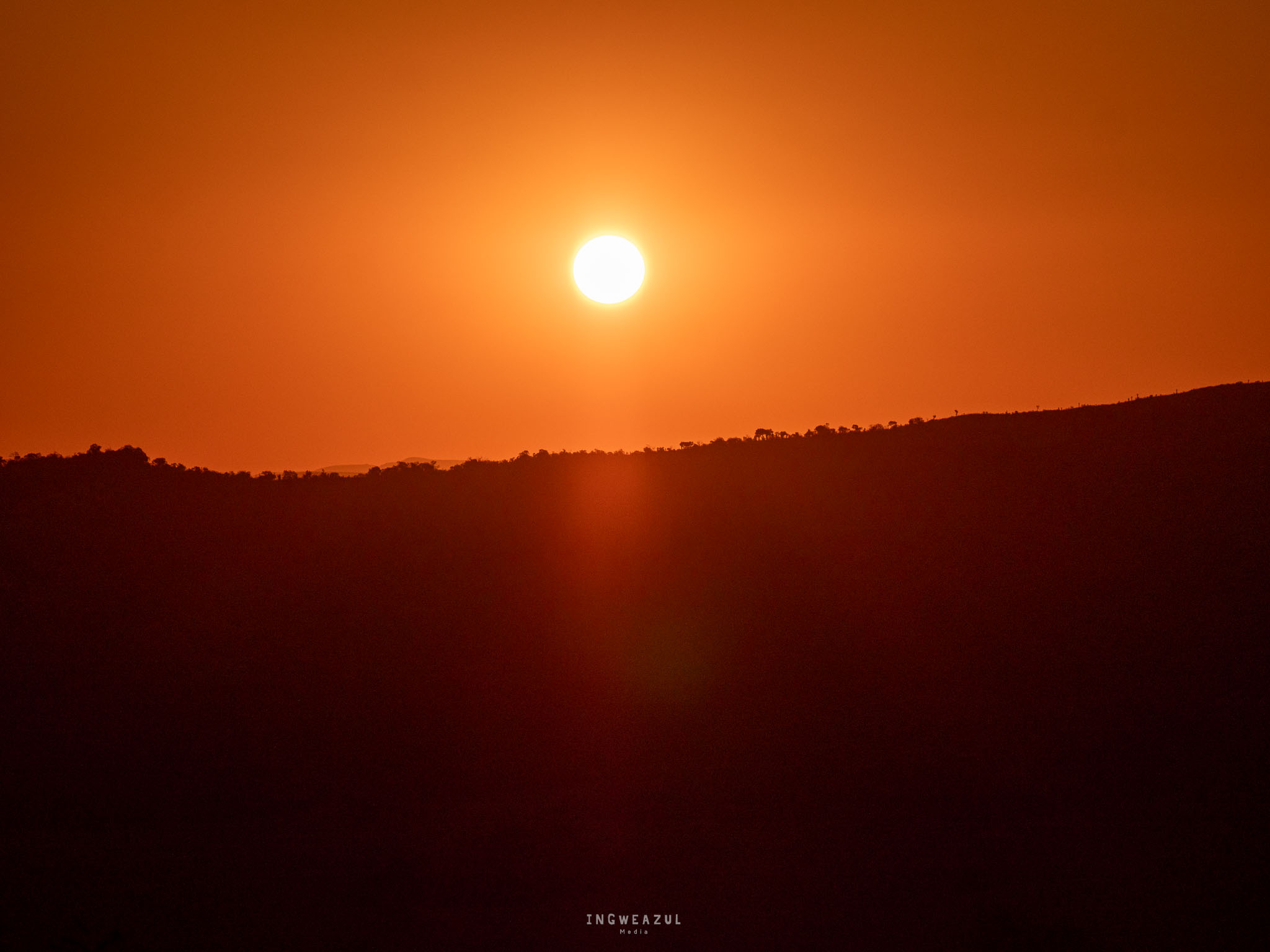 Sunset on Babanango Game Reserve with rolling hills as silhouette