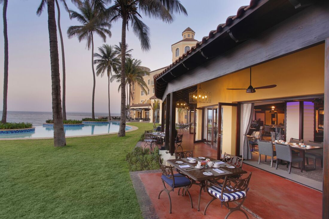 Maputo Lawn of Accommodation and palms overlooking the ocean.