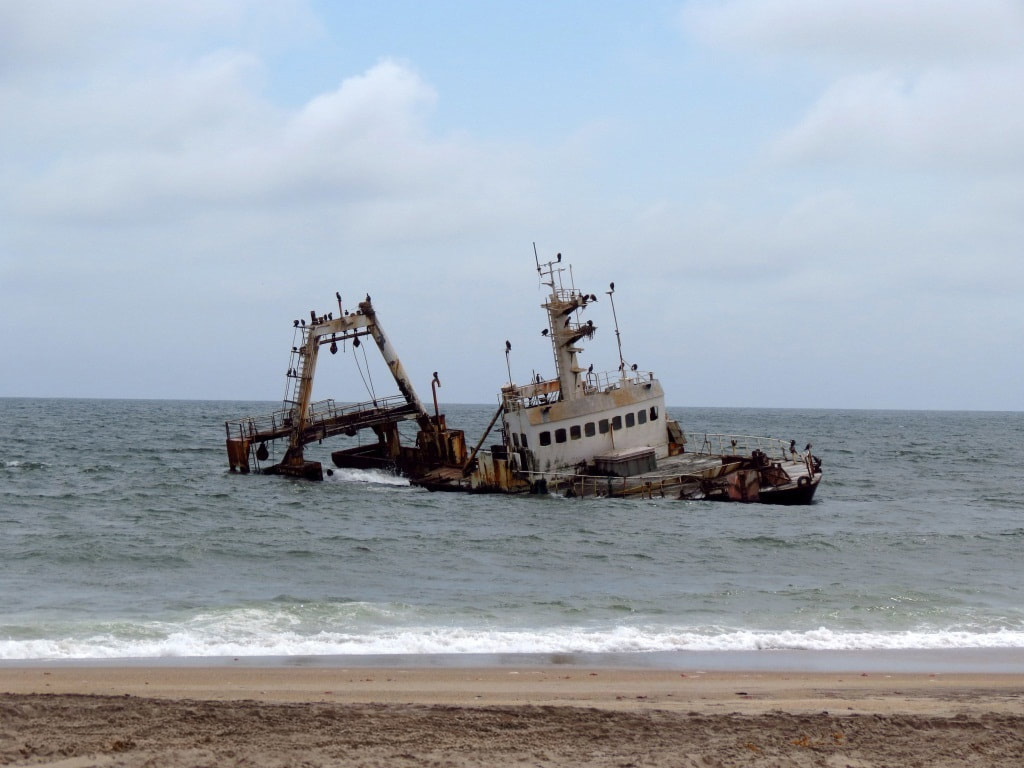 Shipwreck just off the beach on the Skeleton Coast in Namibia