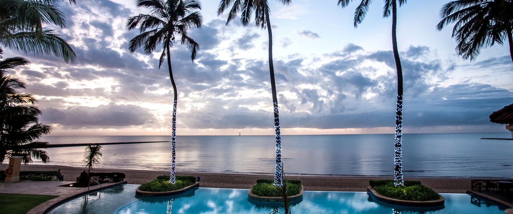 Swimming pool in a tropical setting of palms overlooking the ocean in Maputo