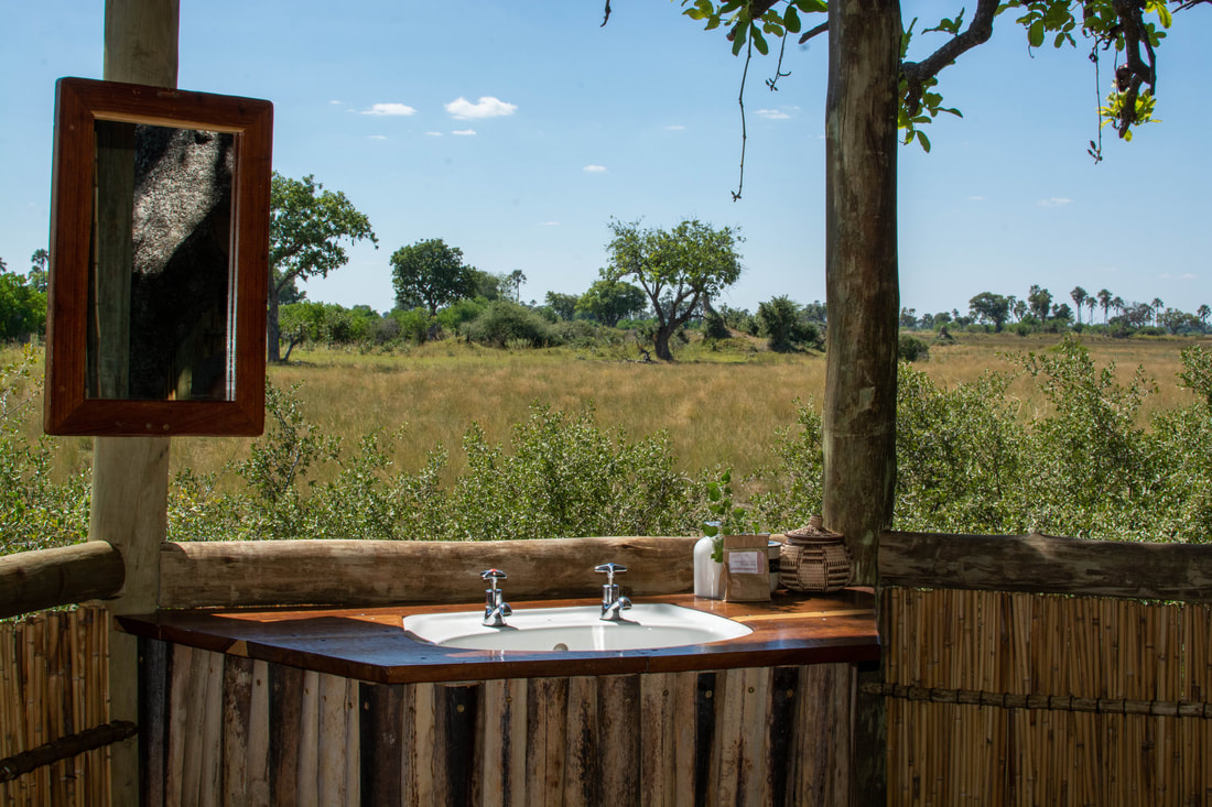 A view from a bathroom basin overlooking the field.