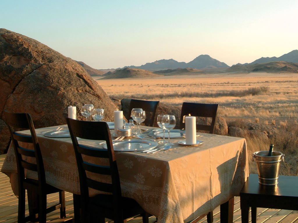 a table set for a meal overlooking the mountainous area of NambiRand