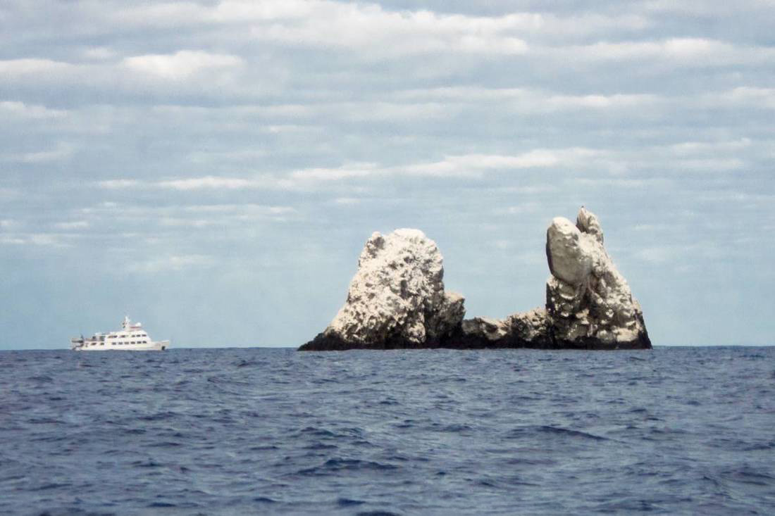 View of the Roca Partida outcrop around Socorro Island with the Nautilus Liveaboard next to it.