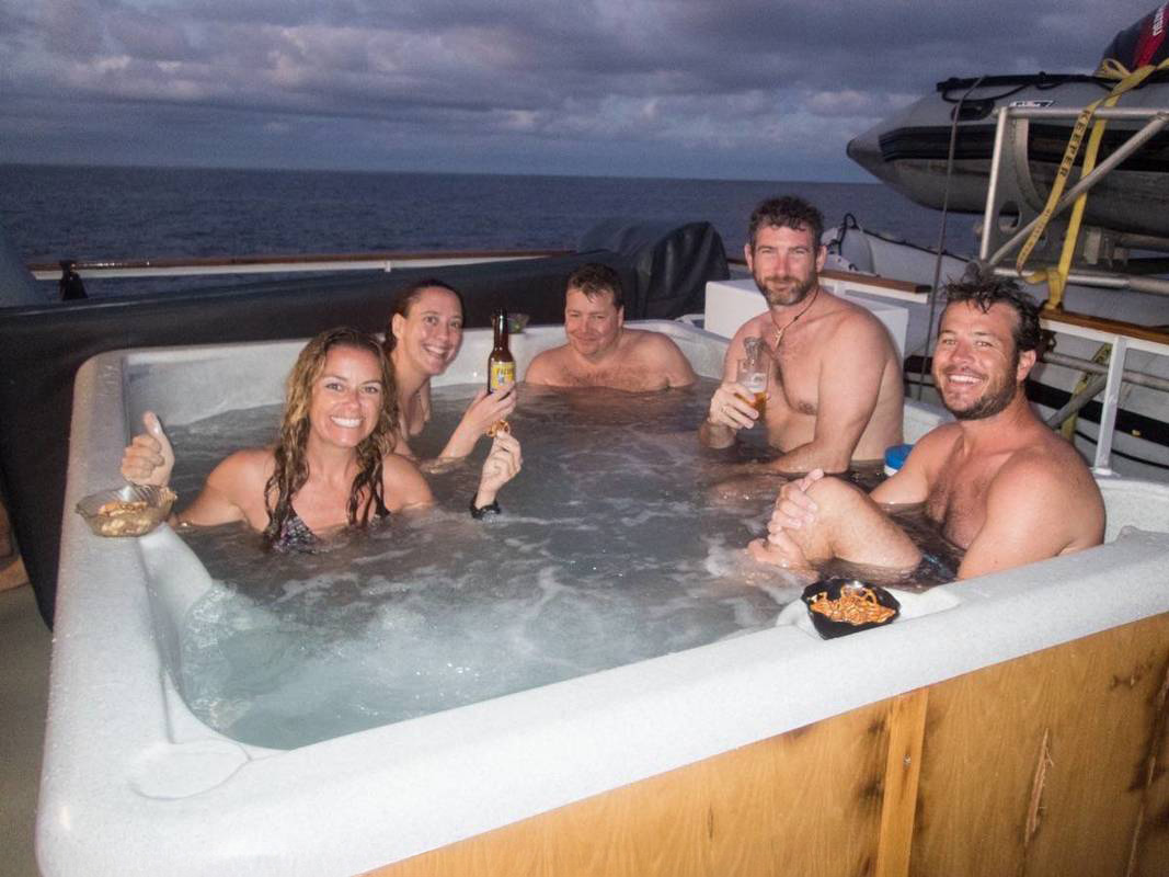 Guests on Nautilus boat in Socorro enjoying evening sundowners in the jacuzzi.
