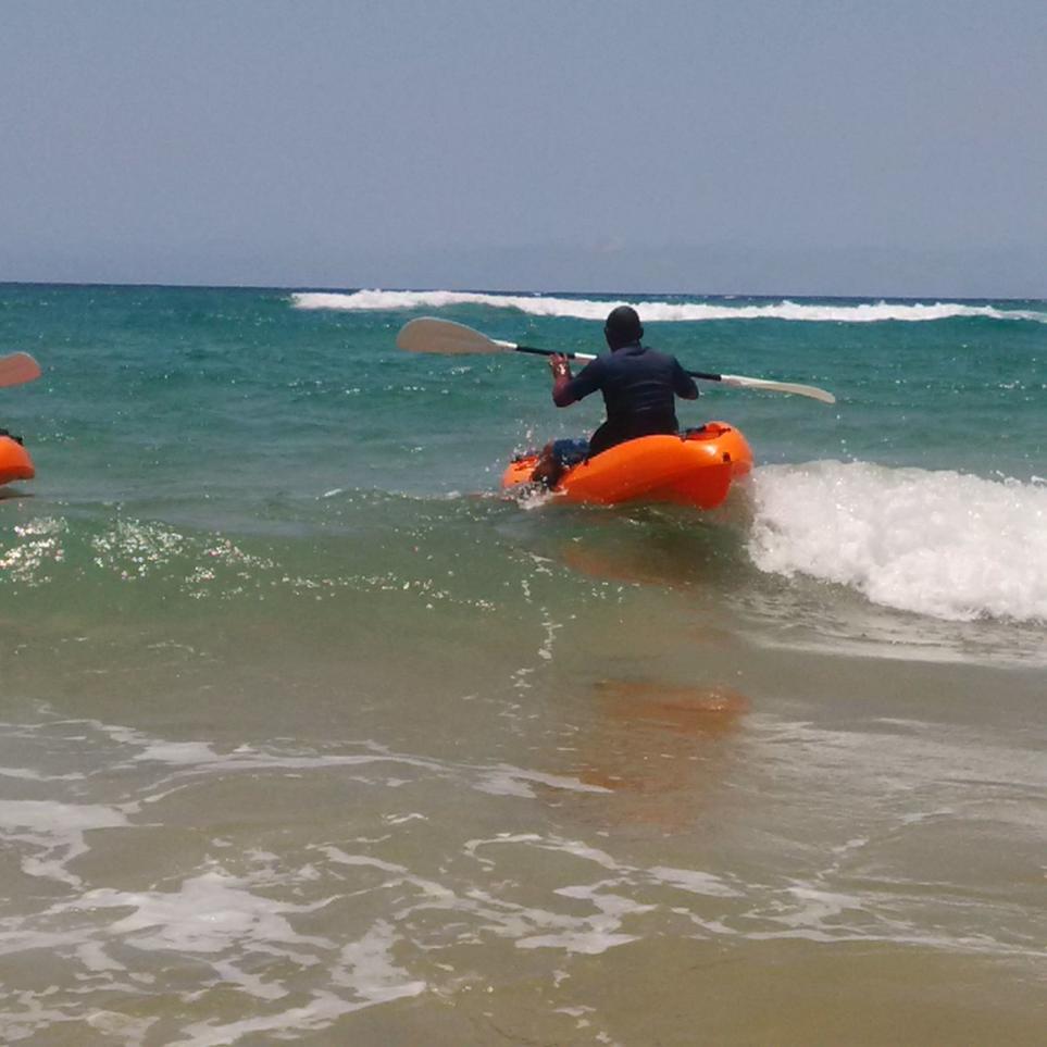 Ponta Do Oura kayakers navigating the small waves into the ocean.