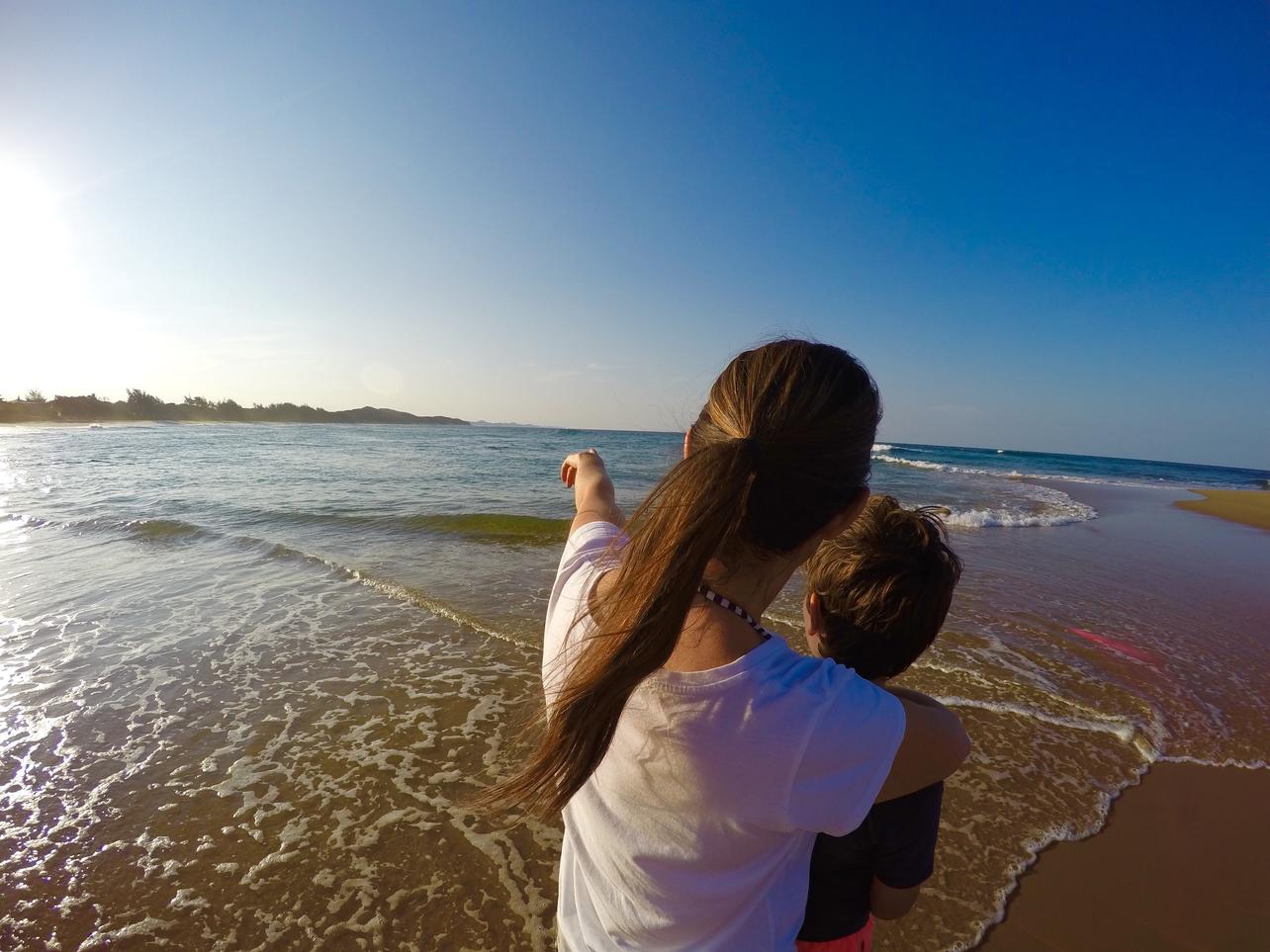 Mohter and son on the beach enjoying the views
